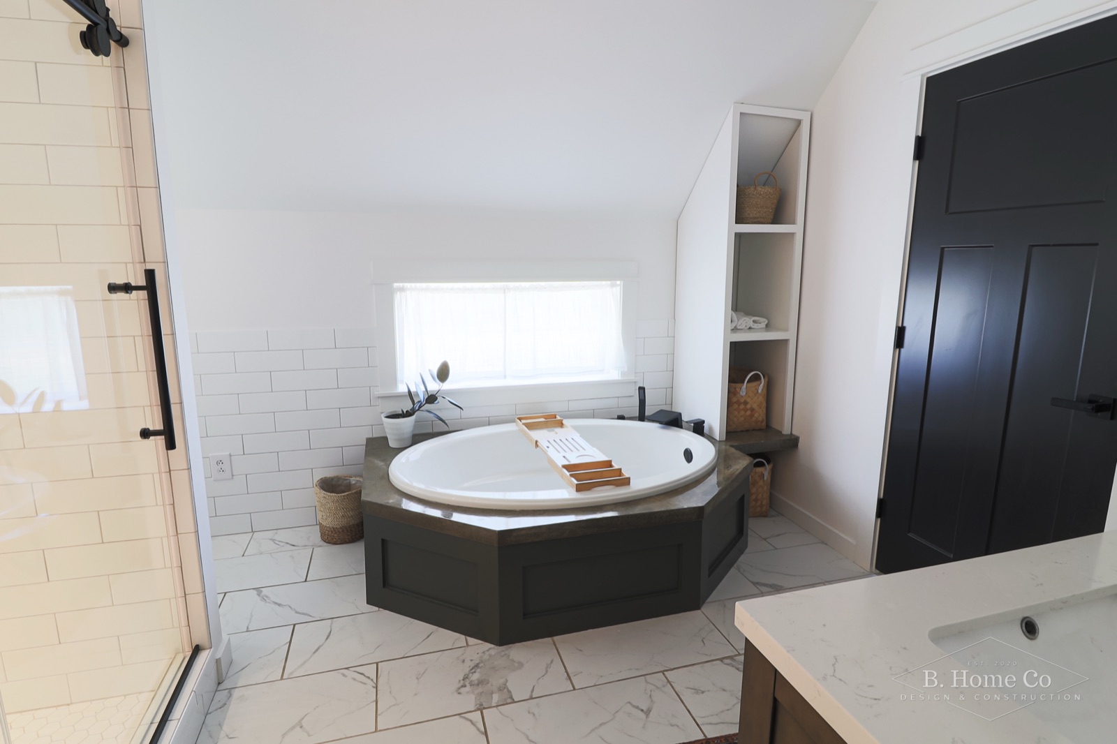 Soaking tub framed by white subway tile