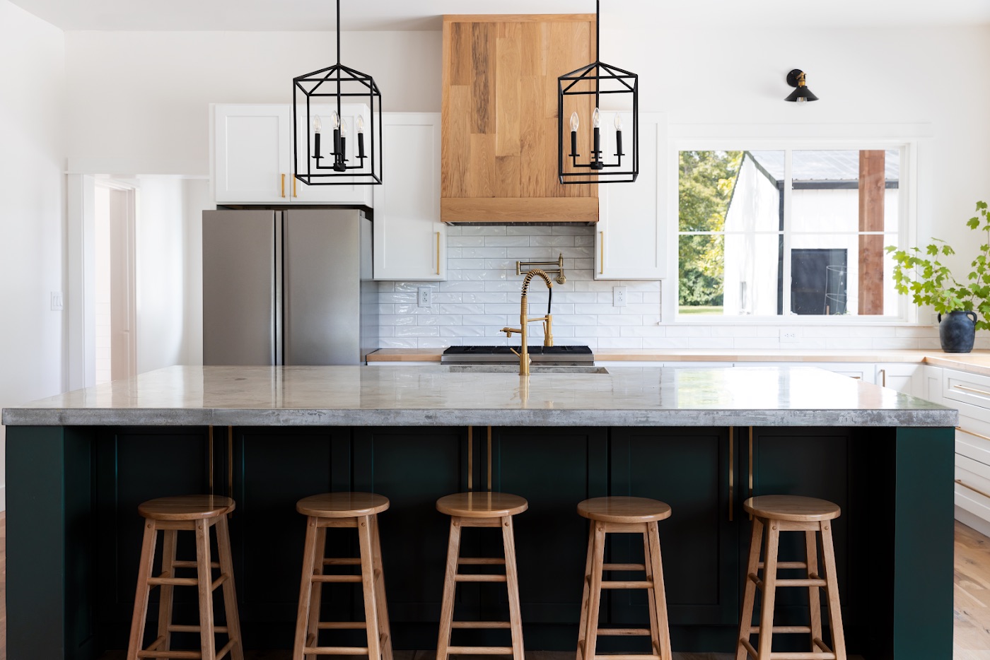 Custom wood range hood and marble island in the renovated kitchen