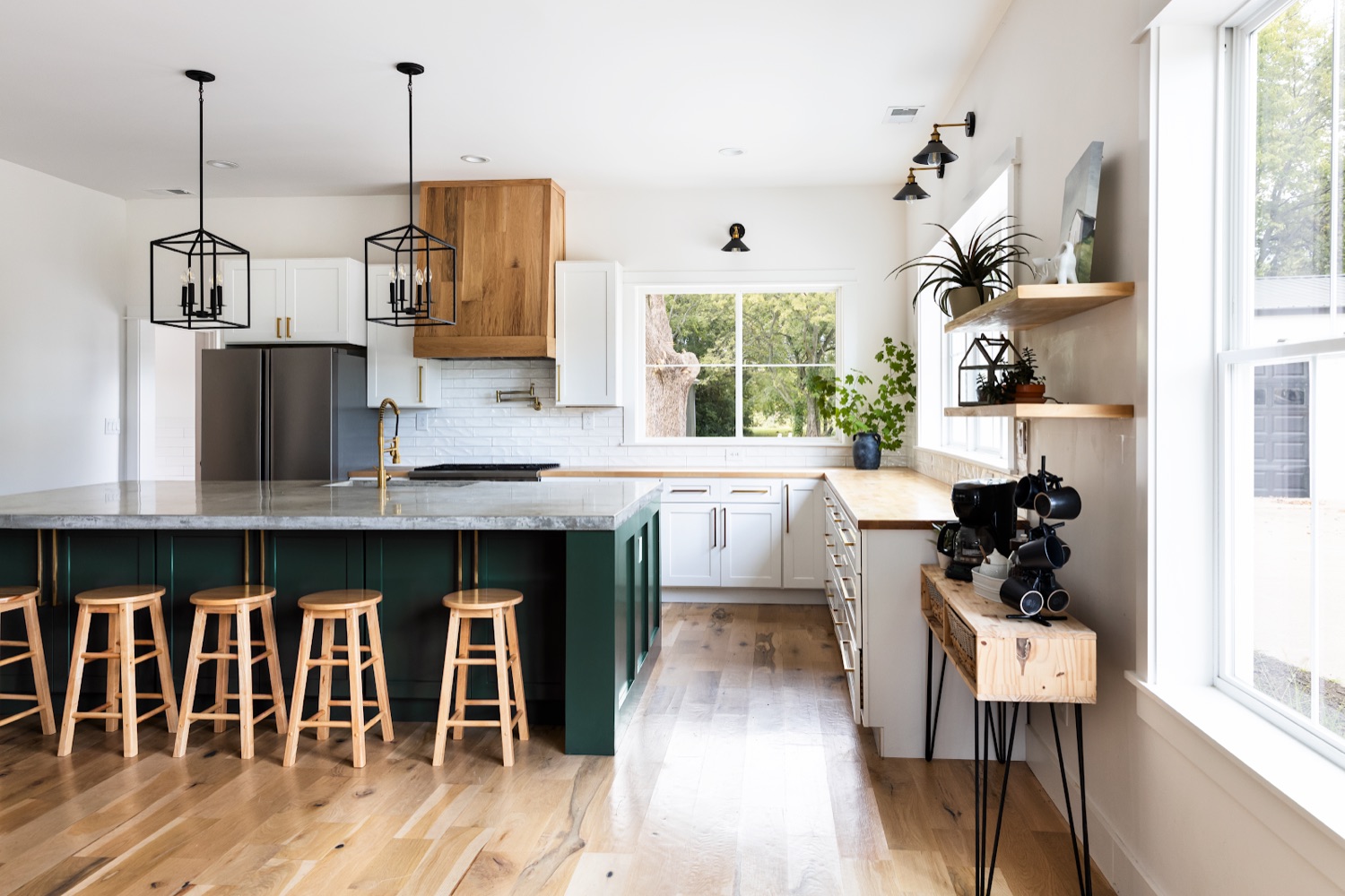 Open kitchen with floating wood shelves and oak floors